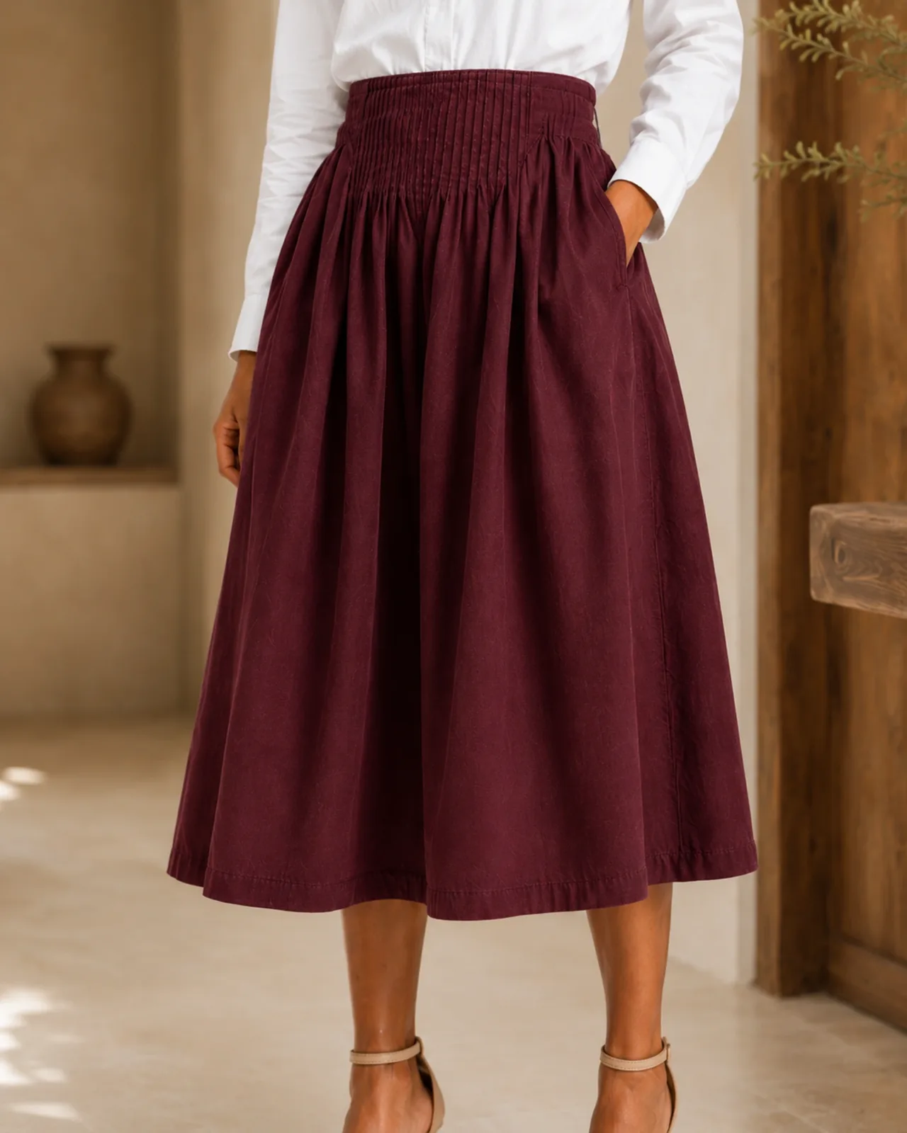 Pintuck yoke on the Amara midi skirt in burgundy